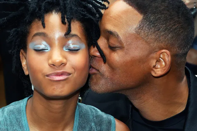Actor Will Smith, right, kisses his daughter Willow prior to Chanel's Haute Couture Fall-Winter 2016-2017 fashion collection presented Tuesday, July 5, 2016 in Paris. (Photo by Thibault Camus/AP Photo)