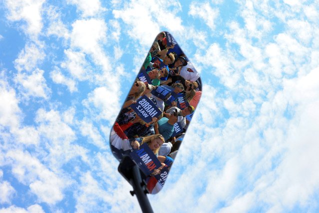 A reflection shows supporters gathering ahead of U.S. Vice President and Democratic presidential candidate Kamala Harris and her running mate Minnesota Governor Tim Walz's campaign event in Eau Claire, Wisconsin on August 7, 2024. (Photo by Kevin Mohatt/Reuters)