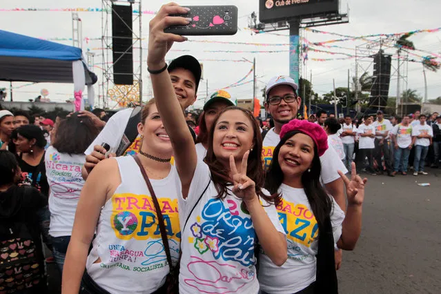 Supporters of Nicaragua's President Daniel Ortega take a selfie during celebrations for the 37th anniversary of the “Repliegue” (Withdrawal), a historic tactical military guerrilla offensive that enabled the triumph of the Sandinista Revolution on July 19, 1979 in Managua, Nicaragua July 8,2016. (Photo by Oswaldo Rivas/Reuters)
