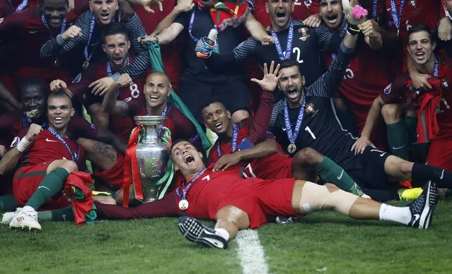 Football Soccer, Portugal vs France, EURO 2016, Final - Stade de France, Saint-Denis near Paris, France on July 10, 2016. Portugal's Cristiano Ronaldo celebrates with team mates and the trophy after winning Euro 2016. (Photo by Carl Recine/Reuters/Livepic)