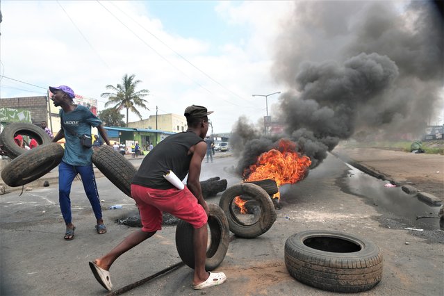 Smoke rises as demonstrators place tires in a burning barricade during a post-election protest, in a street of Maputo, Mozambique, 06 December 2024. In recent weeks, supporters of former presidential candidate Venancio Mondlane, who is currently in exile, have taken to the streets of the Mozambican capital to challenge the results of the disputed general election held in October 2024. (Photo by Luisa Nhantumbo/EPA/EFE)