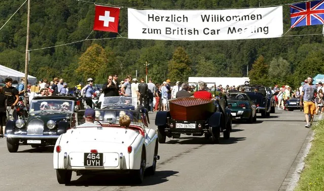 Participants arrive in their vintage cars during the British Car Meeting 2015 in the village of Mollis, east of Zurich, August 30, 2015. (Photo by Arnd Wiegmann/Reuters)