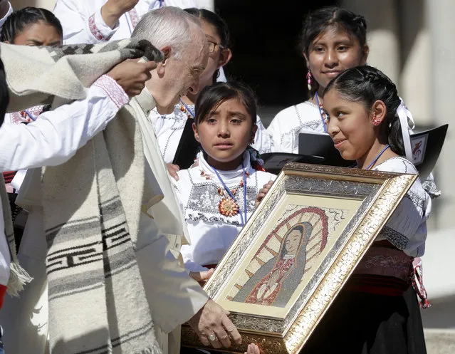 Pope Francis bless an image of Our Lady of Guadalupe presented to him by a group of faithful from Mexico, during his weekly general audience in St. Peter's Square, at the Vatican, Wednesday, September 20, 2017. The pontiff prayed for the victims of the 7.1 magnitude quake that hit Mexico on Tuesday leaving several hundred dead, including children trapped under a collapsed school in Mexico City. (Photo by Andrew Medichini/AP Photo)