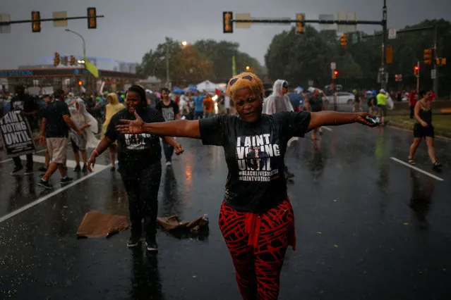 “Black Lives Matter” activists react to heavy rain fall as they gather to protest outside the site of the 2016 Democratic National Convention in Philadelphia, Pennsylvania July 25, 2016. (Photo by Adrees Latif/Reuters)