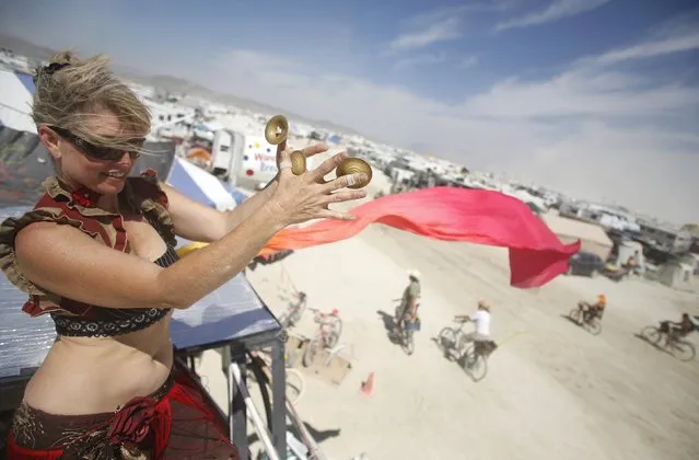 Paulina Carey dances during the Burning Man 2014 “Caravansary” arts and music festival in the Black Rock Desert of Nevada, August 30, 2014. (Photo by Jim Urquhart/Reuters)