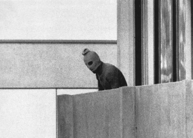 A member of the Arab Commando group which seized members of the Israeli Olympic Team at their quarters at the Olympic Village appearing with a hood over his face stands on the balcony of the building where the commandos held members of the Israeli team hostage in Munich, Sept. 5, 1972. The German government indicated Wednesday that it is willing to pay further compensation for the families of the Israeli athletes killed in an attack at the 1972 Munich Olympics following decades-long criticism from relatives over how Germany handled the attack and its aftermath. (Photo by Kurt Strumpf/AP Photo/File)