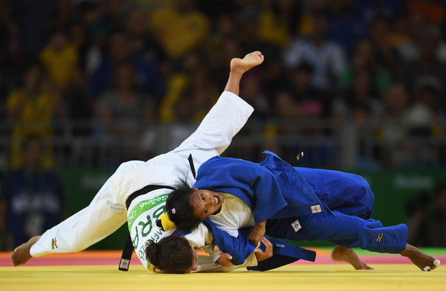 Dayaris Mestre Alvarez of Cuba (blue) competes against Sarah Menezes of Brazil in the Women's -48 kg Judo on Day 1 of the Rio 2016 Olympic Games at Carioca Arena 2 on August 6, 2016 in Rio de Janeiro, Brazil. (Photo by Laurence Griffiths/Getty Images)