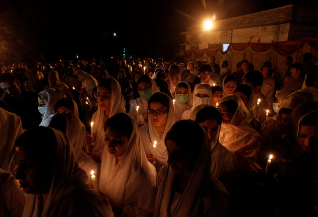 Nurses hold candles to honour victims of the Monday blast at Civil Hospital, during a candle light vigil in Quetta, Pakistan, August 10, 2016. (Photo by Naseer Ahmed/Reuters)