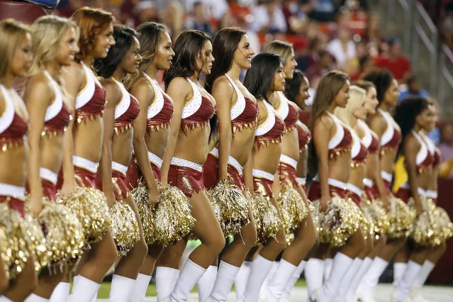 The Washington Redskins cheerleaders perform during the first half of an NFL football preseason game against the New England Patriots in Landover, Md., Thursday, August 7, 2014. (Photo by Alex Brandon/AP Photo)