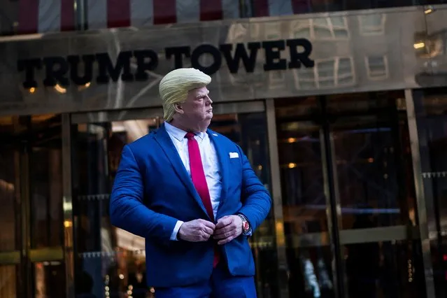 A person wearing a mask of former U.S. president Donald Trump impersonates him in front of Trump Tower in the Manhattan borough in New York, U.S., October 18, 2022. (Photo by Eduardo Munoz/Reuters)
