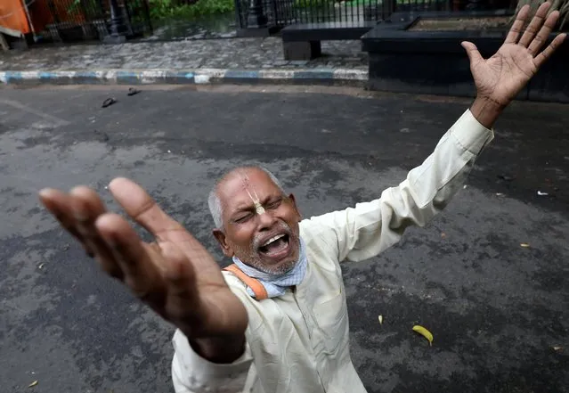 A Hindu devotee reacts after ISKCON (International Society of Krishna Consciousness) cancelled the annual Rath Yatra, or chariot procession, amidst the coronavirus disease (COVID-19) outbreak, in Kolkata, India, June 23, 2020. (Photo by Rupak De Chowdhuri/Reuters)