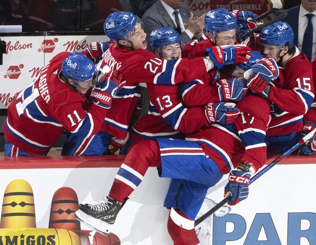 Montreal Canadiens' Josh Anderson (17) gets mobbed by by teammates on the bench after his empty net goal during the third period of an NHL hockey game against the Ottawa Senators, in Montreal on Tuesday, March 18, 2025. (Photo by Christinne Muschi/The Canadian Press via AP Photo)