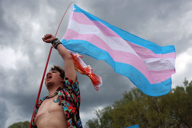 A person holds a flag during a Transgender Day of Visibility rally on the National Mall in Washington on March 31, 2025. (Photo by Evelyn Hockstein/Reuters)