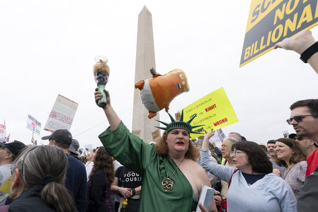 A demonstrator dressed as the Statue of Liberty participates in the “Hands Off!” protests against President Donald Trump at the Washington Monument in Washington, Saturday, April 5, 2025. (Photo by Jose Luis Magana/AP Photo)