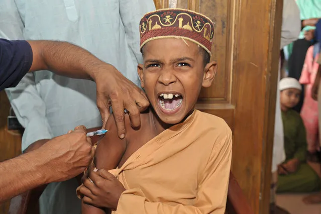 Health workers vaccinate students aged 5-11 years on November 2, 2022 at Bholaganj Islamic Madrasa in Bholaganj, an Upazila bordering Sylhet. (Photo by Md Rafayat Haque Khan/ZUMA Press Wire/Rex Features/Shutterstock)