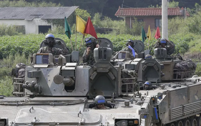 South Korean army soldiers ride their armored vehicles during an annual exercise in Paju, South Korea, near the border with North Korea, Sunday, September 11, 2016. The U.N. Security Council is strongly condemning North Korea's latest nuclear test and says it will start discussions on “significant measures” against Pyongyang including new sanctions. (Photo by Ahn Young-joon/AP Photo)