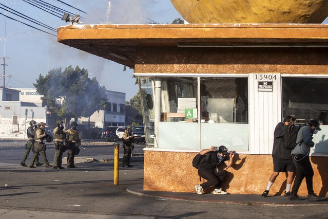 Los Angeles County Sheriffs are seen as law enforcement clashes with demonstrators during a protest following federal immigration operations, in the Compton neighborhood of Los Angeles, California on June 7, 2025. US President Donald Trump deployed 2,000 troops on June 7, 2025 to handle escalating protests against immigration enforcement raids in the Los Angeles area, a move the state's governor termed “purposefully inflammatory”. Federal agents clashed with angry crowds in a Los Angeles suburb as protests stretched into a second night Saturday, shooting flash-bang grenades and shutting part of a freeway amid raids on undocumented migrants, reports said. (Photo by Ringo Chiu/AFP Photo)