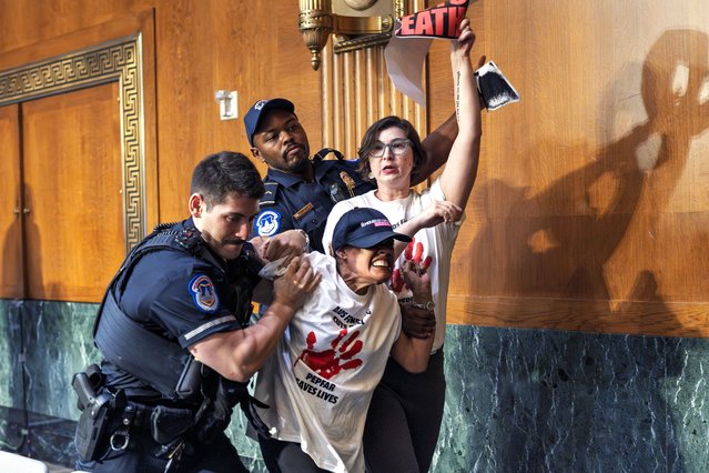 U.S. Capitol Police remove protesters after they began shouting in a Senate Appropriations Committee hearing as Office of Management and Budget director Russell Vought begins to testify on the rescissions package, at the Capitol in Washington, Wednesday, June 25, 2025. (Photo by J. Scott Applewhite/AP Photo)