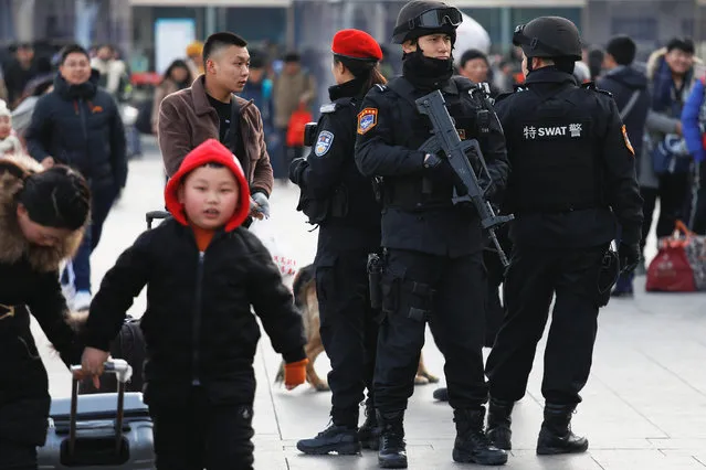 Members of a SWAT team take positions at the Beijing Railway Station as the annual Spring Festival travel rush begins ahead of the Chinese Lunar New Year, in central Beijing, China on February 1, 2018. (Photo by Damir Sagolj/Reuters)