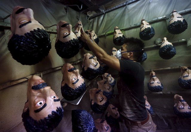 An employee checks Guzman masks hanging off hooks at Grupo Rev in the Mexican city of Cuernavaca near Mexico City October 14, 2015. (Photo by Henry Romero/Reuters)