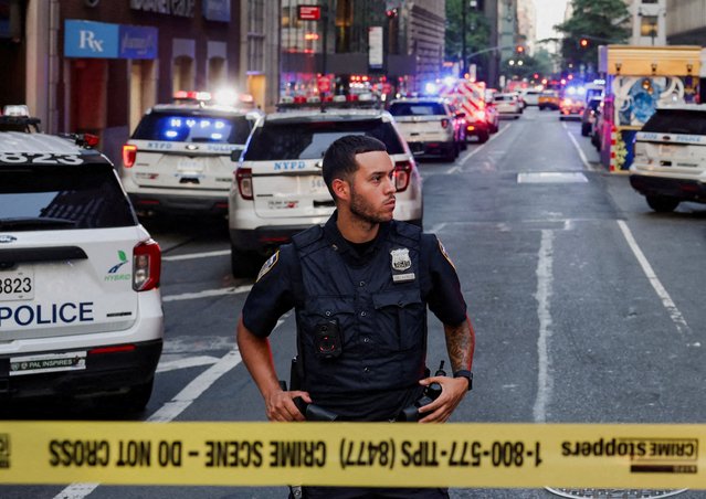 A police officer stands guard in a cordoned off area during a reported active shooter situation in the Manhattan borough of New York City on July 28, 2025. (Photo by Jeenah Moon/Reuters)
