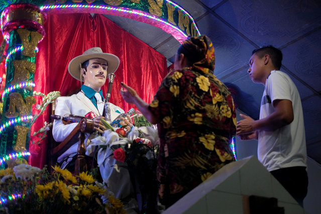 People worship San Simon at the San Simon pagan chapel during San Simon holiday in Cuyultitan, El Salvador, October 28, 2020. (Photo by Jose Cabezas/Reuters)