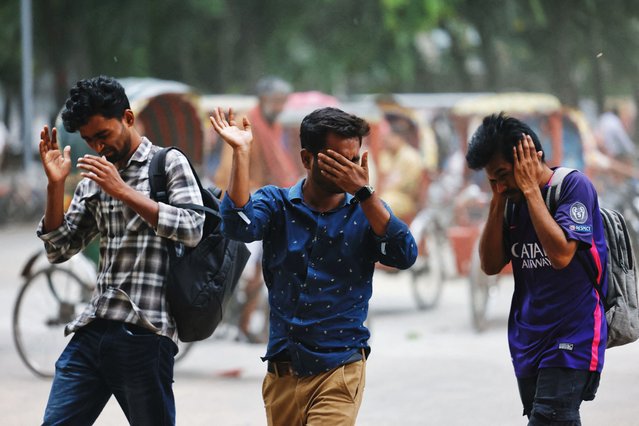 Pedestrians react as storm blows dust into the air, in Dhaka, Bangladesh on May 26, 2025. (Photo by Mohammad Ponir Hossain/Reuters)