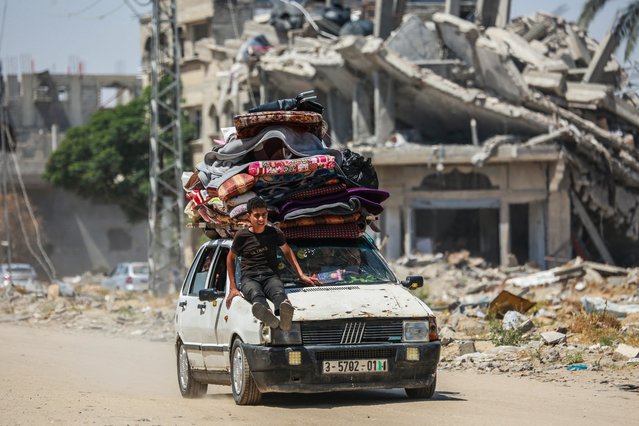Displaced Palestinians arrive in a car carrying their belongings to set up shelter after returning to Khan Yunis in the southern Gaza Strip on May 9, 2024, amid the ongoing conflict between Israel and the Palestinian militant group Hamas. (Photo by AFP Photo/Stringer)