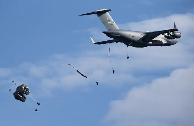 U.S. Paratroopers from the 82nd Airborne Division based in Fort Brag, N.C. , participate in a massive airdrop from C-17 Globemaster aircraft as part of the NATO Exercise Trident Juncture 2015 military exercise, NATO's largest  joint and combined military exercise in more than a decade, at the San Gregorio training grounds outside Zaragoza, Spain, November 4, 2015. (Photo by Paul Hanna/Reuters)