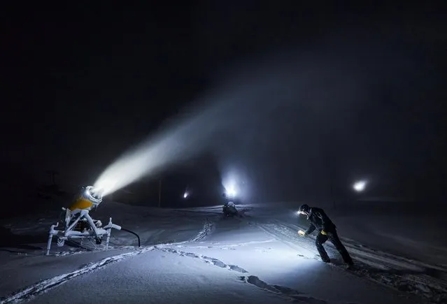 Snowmaker Guy Arnaud checks the quality of snow made by the machine during his shift, before the official opening of the Alpine ski resort of Verbier on December 5, amid the coronavirus disease (COVID-19) outbreak, in Verbier, Switzerland on December 1, 2020. (Photo by Denis Balibouse/Reuters)