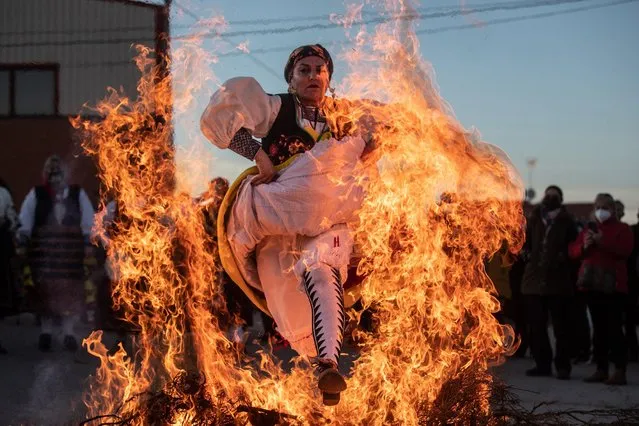 People celebrate the traditional Fiesta de las Aguedas on February 6, 2022 in Andavias, Zamora, Castilla y Leon, Spain. This celebration, also known as “El dia de las mujeres”, is a deep-rooted tradition in Castilla y Leon, especially in rural areas. The day of the Aguedas has its origin in the cult of Santa Agueda, and is celebrated every February 5. During this day, women are the protagonists and take over the city. For their part, the town councils give them the baton as a sign of authority. Around seven days of festivities are celebrated where the attendees dance, eat, sing, and even jump over a bonfire. (Photo By Emilio Fraile/Europa Press via Getty Images)