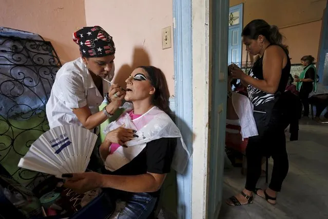 Lilia Lorenzo (L) applies makeup on her mother Idalis Lorenzo during a school of theatre, makeup and hair styling graduation contest in Havana, November 16, 2015. (Photo by Reuters/Stringer)