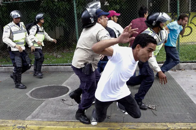 Demonstrators clash with riot police during a student rally demanding a referendum to remove Venezuela's President Nicolas Maduro in Caracas, Venezuela October 24, 2016. (Photo by Marco Bello/Reuters)