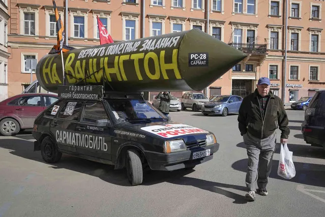 A vehicle with a mock Russian missile with the inscription reading “Let's program it again to target Washington” goes in St. Petersburg, Russia, Friday, April 14, 2023. Pro-Kremlin activist Ravil Garifullin, a resident of the city of Kazan makes a four-month propaganda rally in his car across Russia. (Photo by Dmitri Lovetsky/AP Photo)