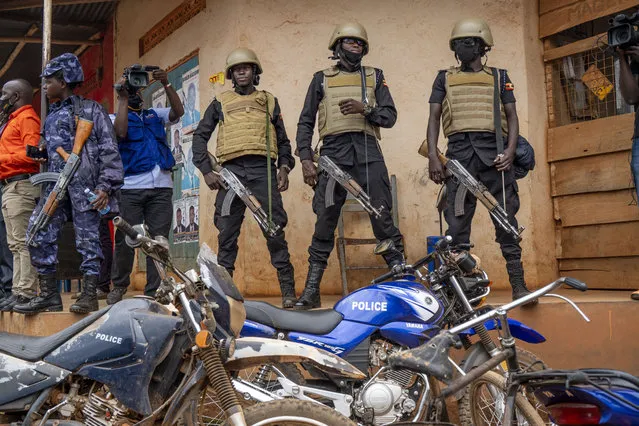Security forces stand outside a polling station in Kampala, Uganda, Thursday, January 14, 2021.  Ugandans are voting in a presidential election tainted by widespread violence that some fear could escalate as security forces try to stop supporters of leading opposition challenger Bobi Wine from monitoring polling stations. (Photo by Jerome Delay/AP Photo)