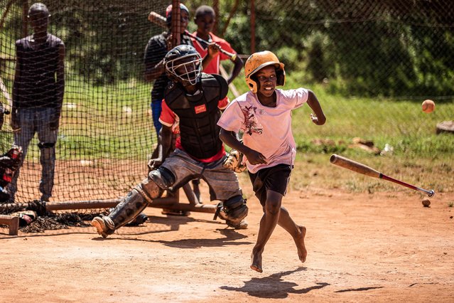 A Ugandan baseball player trains with Dennis Kasumba (C), 18, who dreams of becoming Uganda's first US's Major League Baseball (MLB) player at Gayaza Baseball and Softball Sports Club Ground in Gayaza, Uganda, on May 22, 2023. Noticed online after videos of his talent and creativity went viral, Dennis Kasumba received an invitation to the Major League Baseball (MLB) Draft League, which starts on June 1 in the United States. (Photo by Badru Katumba/AFP Photo)