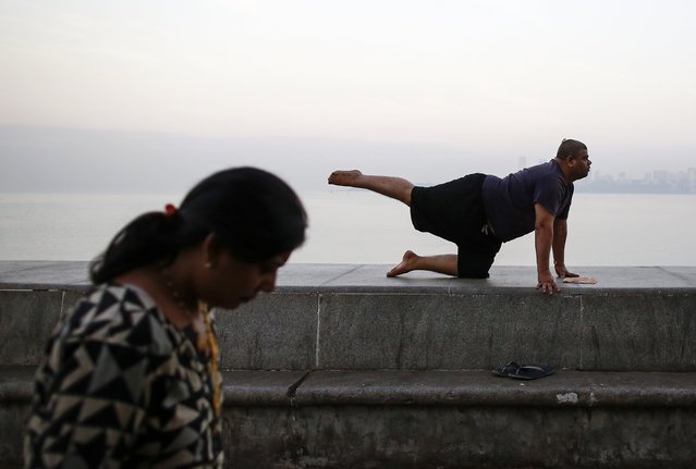 A man exercises early morning on a wall along the Arabian Sea in Mumbai January 22, 2015. (Photo by Danish Siddiqui/Reuters)