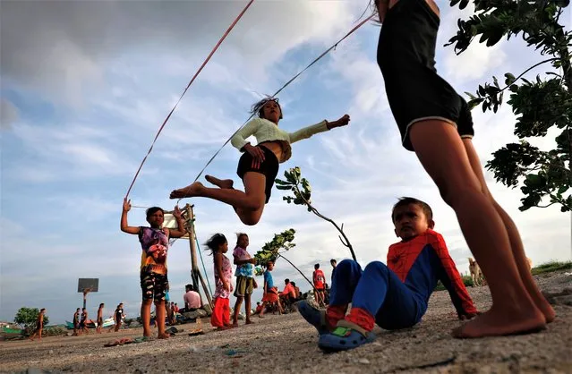 Filipino children play at a fishing village along the coast of Manila Bay, Philippines, 30 May 2023. As a precaution of approaching Typhoon Mawar, Philippine government authorities have evacuated thousands of residents, imposed a no-sail ban, suspended school classes, and shutdown offices in the northern part of Luzon island, the country's largest and most populous island. (Photo by Francis R. Malasig/EPA/EFE/Rex Features/Shutterstock)