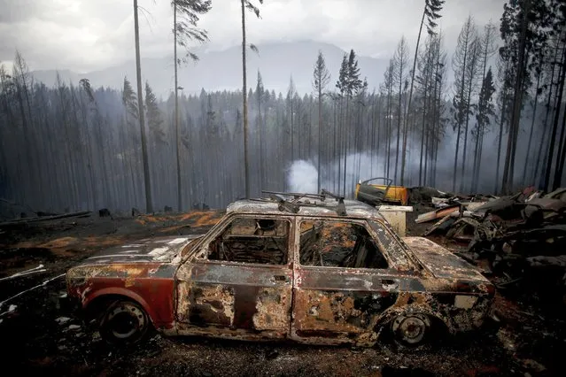 The shell of a burned car sits in a field ravaged by a forest fire in Las Golondrinas, in the Chubut southern province of Argentina, Wednesday, March 10, 2021. (Photo by Matias Garay/AP Photo)
