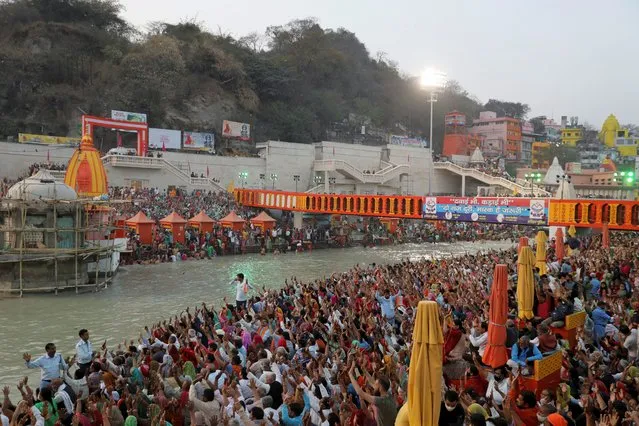 Devotees gather on the banks of Ganges river to pray ahead of the first Shahi Snan at “Kumbh Mela” or the Pitcher Festival, in Haridwar, India, March 10, 2021. (Photo by Anushree Fadnavis/Reuters)