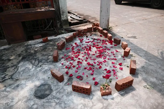 Flower petals are seen at a spot where Aung Than, 41, was killed during a raid by security forces in Thaketa, Yangon, Myanmar on March 13, 2021. (Photo by Reuters/Stringer)