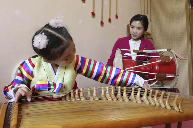 A girl plays kayagum, stringed Korean harp, at the Tongmun kindergarten No.1 in Taedonggang District of Pyongyang, North Korea Tuesday, May 16, 2023. (Photo by Cha Song Ho/AP Photo)