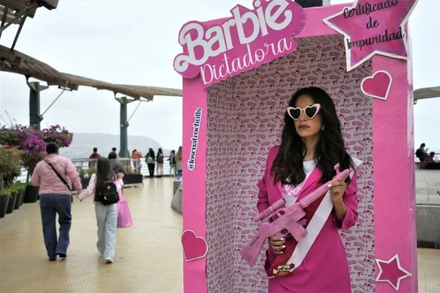 An anti-government protester, dressed as Barbie holding a fake gun, takes part in a demonstration demanding that Peruvian President Dina Boluarte call for immediate presidential elections as well as justice for those who were killed during protests earlier this year after the ouster of her predecessor, in Lima, Peru, Saturday, July 22, 2023. (Photo by Martin Mejia/AP Photo)