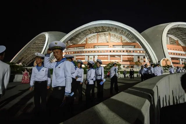 Spectators leave following a 'Mass Games' artistic and gymnastic display at the May Day stadium in Pyongyang on September 9, 2018. The biggest show on earth made a comeback as North Korea put on its its all-singing, all-dancing propaganda display, the “Mass Games”, for the first time in five years. Months in the preparation, the show featured tens of thousands of performers under the curved arches of the May Day Stadium, made up of 17,490 children simultaneously turning the coloured pages of books to create giant images rippling across one side of the stadium  an analogue version, on a giant scale, of a usually digital solution to a digital demand. (Photo by Ed Jones/AFP Photo)