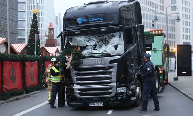 Shattered glass is seen on the windshield of a truck the morning after it ploughed through a Christmas market on December 20, 2016 in Berlin, Germany. Several people have died while dozens have been injured as police investigate the attack at a market outside the Kaiser Wilhelm Memorial Church on the Kurfuerstendamm and whether it is linked to a terrorist plot. (Photo by Sean Gallup/Getty Images)