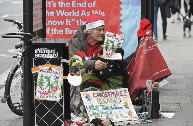 A homeless man sells The Big Issue magazine outside a tube station in north London, Britain December 23, 2016. (Photo by Toby Melville/Reuters)