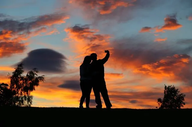 A couple stop and take a selfie with the beautiful sunset last night in Gateshead, a large town in Tyne and Wear, United Kingdom on June 7, 2021. (Photo by NNP)