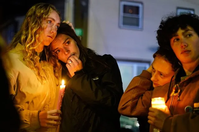 People linger after a vigil for the victims of Wednesday's mass shootings, Sunday, October 29, 2023, outside the Basilica of Saints Peter and Paul in Lewiston, Maine. (Photo by Matt Rourke/AP Photo)