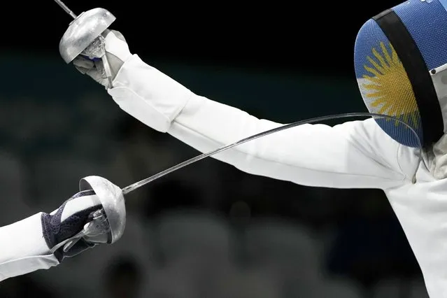 Argentina's Alessandro Taccani, right, faces Venezuela's Daniel Limardo during the teams fencing epee bronze medal match at the Pan American Games in Santiago, Chile, Thursday, November 2, 2023. (Photo by Eduardo Verdugo/AP Photo)