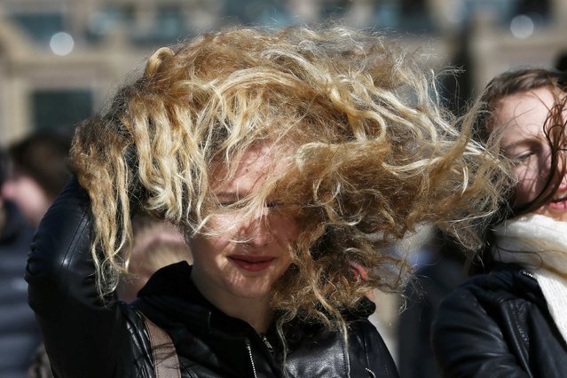 A woman crosses the Millennium Bridge during strong winds in London March 31, 2015. (Photo by Stefan Wermuth/Reuters)